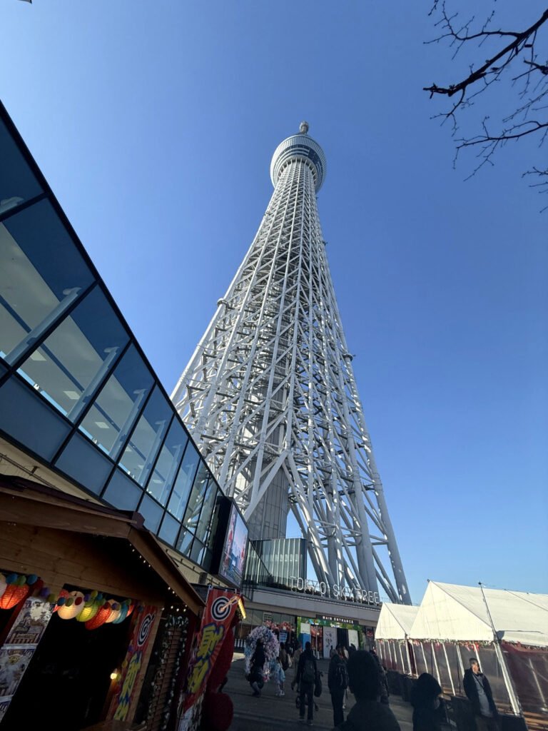 Tokyo Skytree photographed from below against a clear blue sky. 