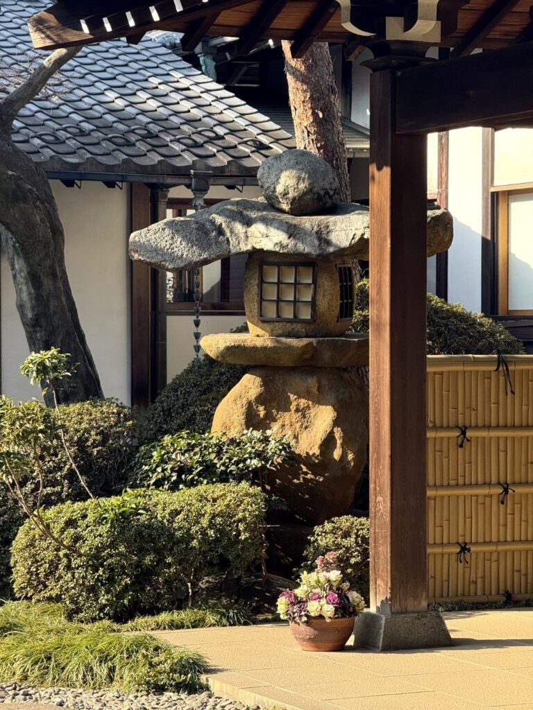 Traditional Japanese stone lantern in a peaceful garden.